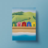 The Secret Path postcard – Saltburn beach huts and surf art by Matt Whaley